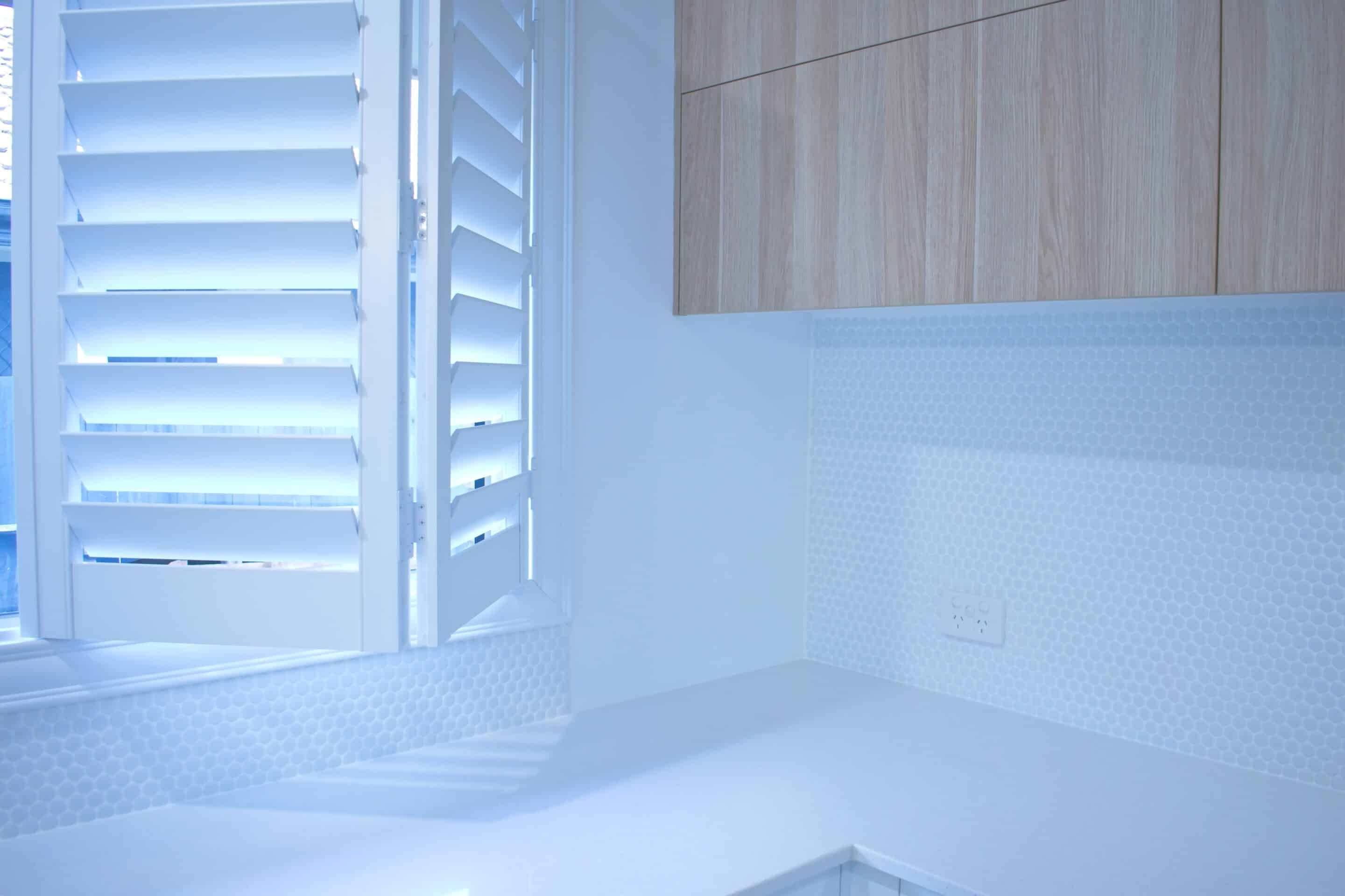 Partly opened bifold plantation shutters.