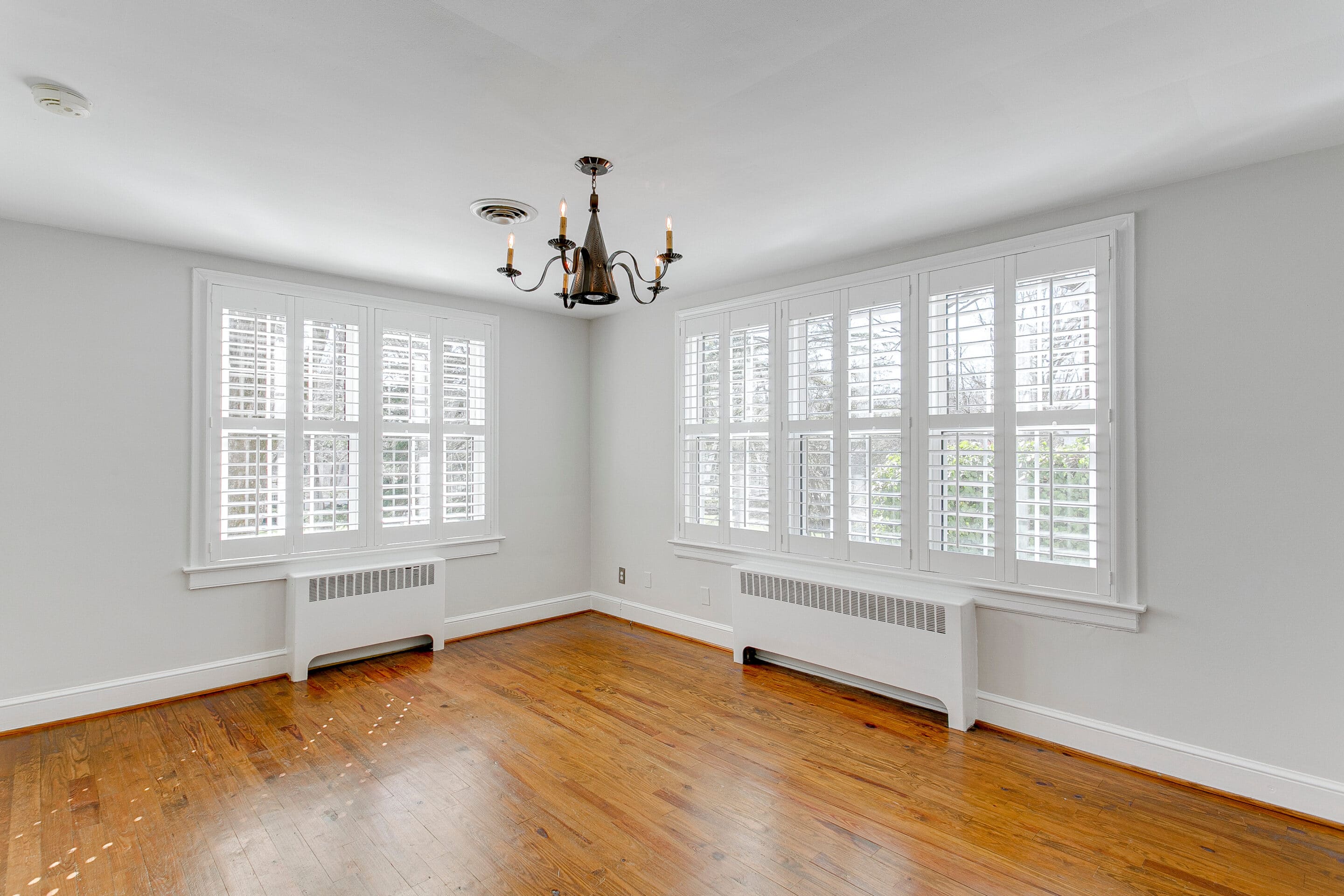 Empty room with bifold shutters, white wooden