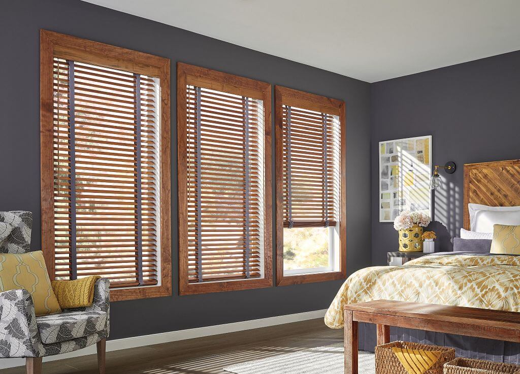Graber wood blinds with decorative tapes installed in bedroom windows