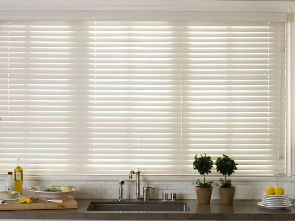 This is a photo of a white faux wood blinds in a kitchen
